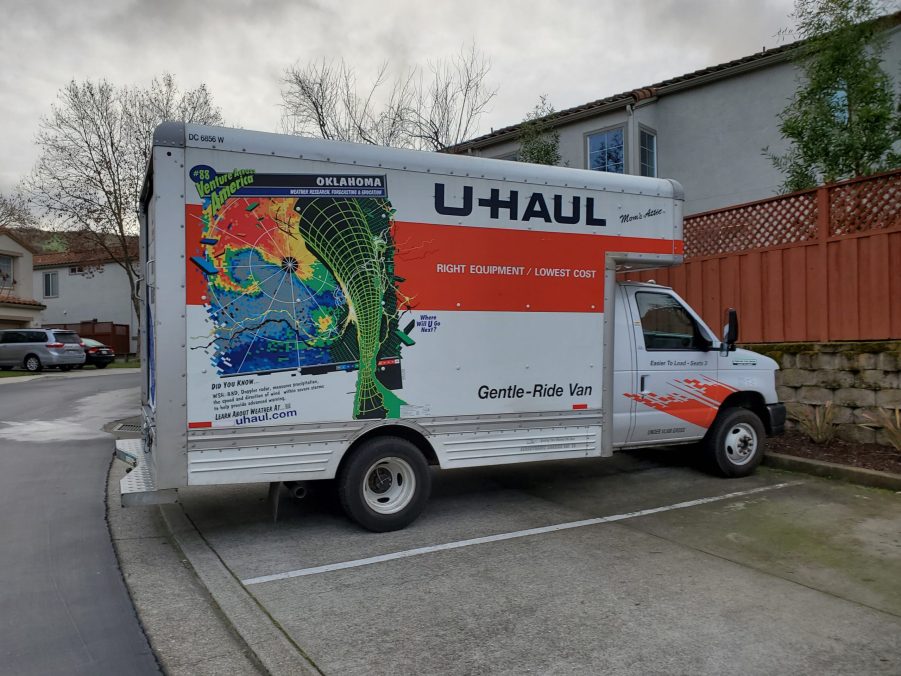 A U-Haul box truck is seen parked in a residential neighborhood.