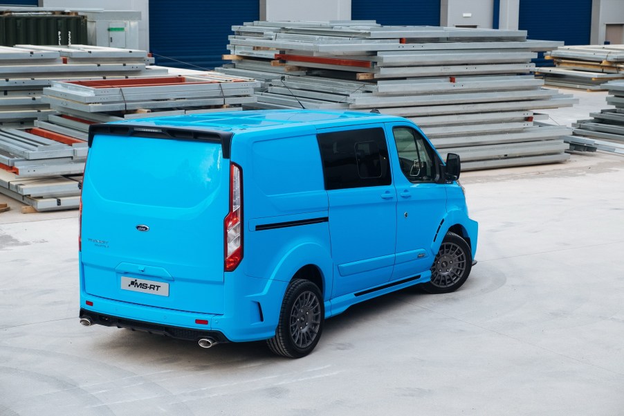 a bright blue Ford Transit connect cargo van working as an urban work truck