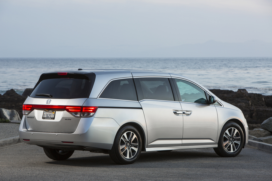 rear view of a silver 215 Honda Odyssey minivan parked near the shore