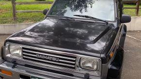 A black 1990 small, tow-door, SUV.