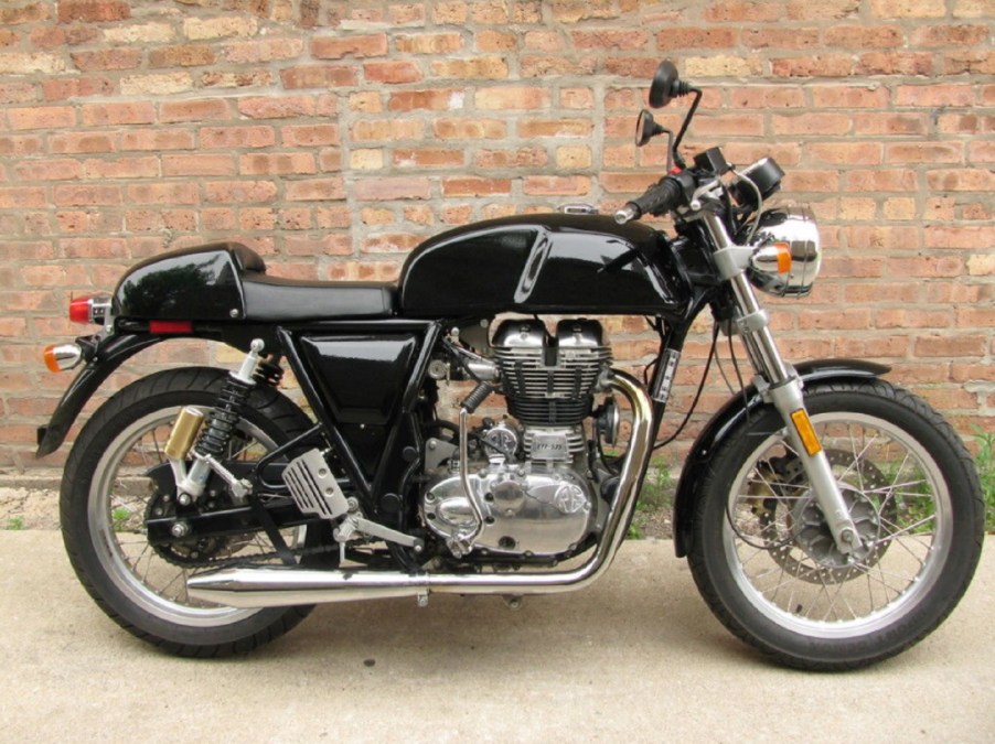 A black 2014 Royal Enfield Continental GT 535 against a brick wall