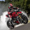 A rider does a burnout on a red 2020 Ducati Streetfighter V4 S