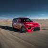 2020 Kia Soul GT-Line in inferno red driving on a track with a blue sky