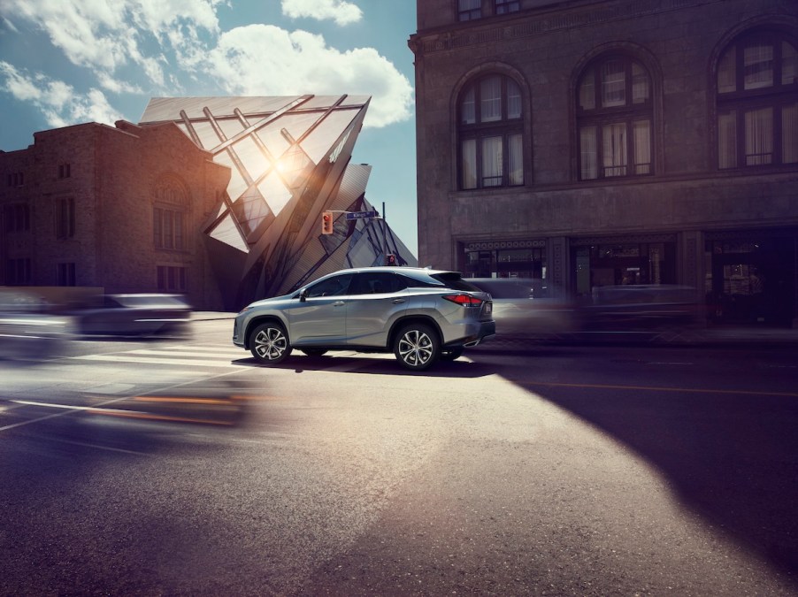 2020 Lexus RX 350 driving through the city near an apartment building