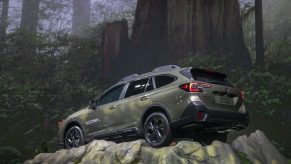 2020 Subaru Outback displaying capability with staged photo on top of a cliffside