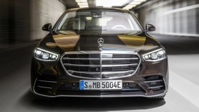 The front of a black 2021 Mercedes-Benz S-Class, showing various sensors and cameras