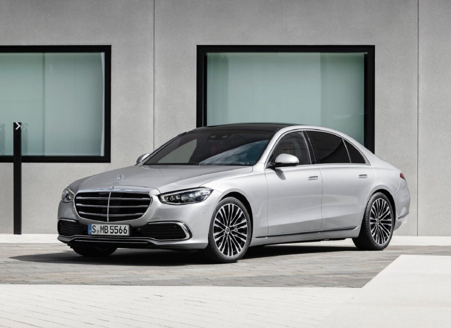 A silver 2021 Mercedes-Benz S-Class in front of a modern building