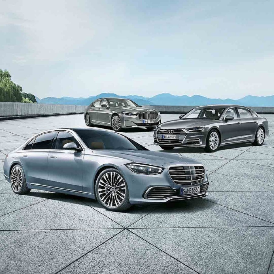 A light-blue 20201 Mercedes S-Class in front of a silver 2020 Audi A8 L in front of a gray 2020 BMW 7 Series