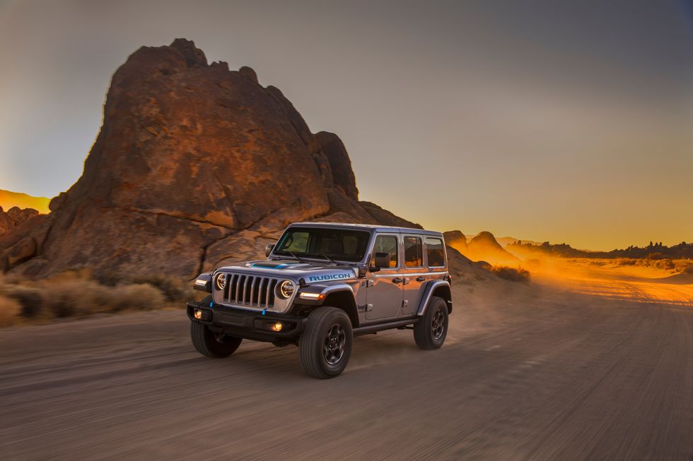 Jeep Wrangler 4xe driving on dirt road