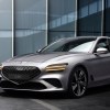 A silver 2022 Genesis G70 in front of some glass windows