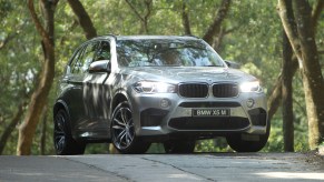 A BMW X5 parked on the street for a photo