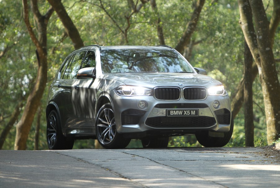 A BMW X5 parked on the street for a photo