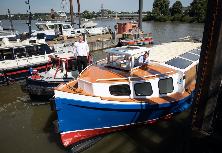 Andreas Dressel (SPD), Senator of Finance in Hamburg, and Michael Glitscher (l), owner and managing director of Elbe- und Hafentouristik GmbH, at a photo session on the modernisation of the first Speicherstadt barge at the C√∂lln shipyard