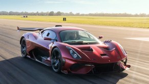 A red Brabham BT62R races down a runway