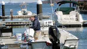 A man ties his boat up to a dock