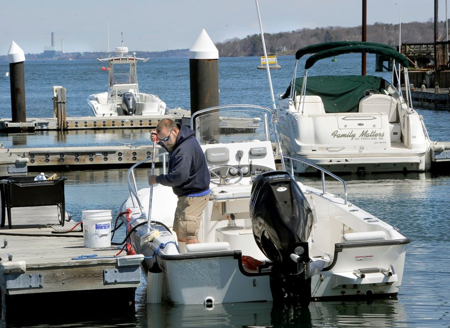 A man ties his boat up to a dock