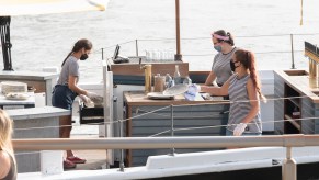 Bartenders work on the Grand Banks boat restaurant at Pier 25 as the city continues Phase 4 of re-opening following restrictions imposed to slow the spread of coronavirus