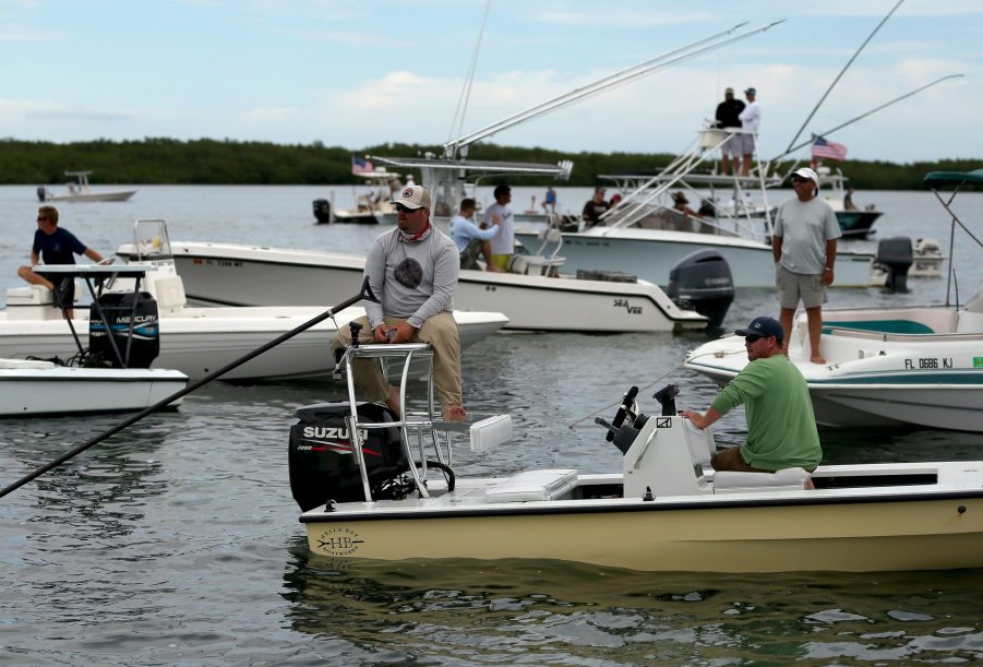 A fishing guide sits on his boat