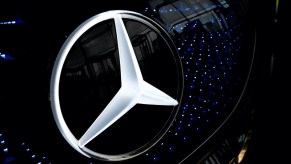 A photo of the Mercedes three-pointed star logo.