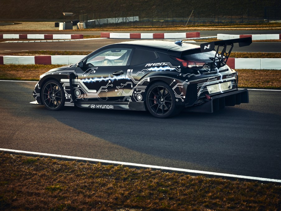 The Hyundai Veloster concept all-electric race car, dubbed the Hyundai RM20e, driving down the straightaway of a race track