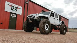 A 2020 Jeep Gladiator on monster wheels outside of the Dakota Customs shop.