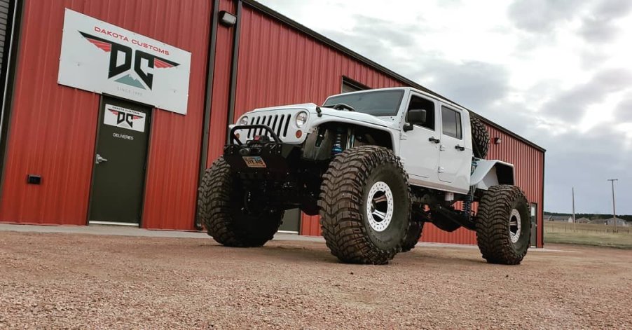 A 2020 Jeep Gladiator on monster wheels outside of the Dakota Customs shop.