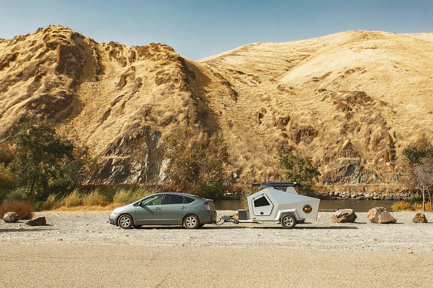 A Toyota Prius hauling a Polydrop RV camper.