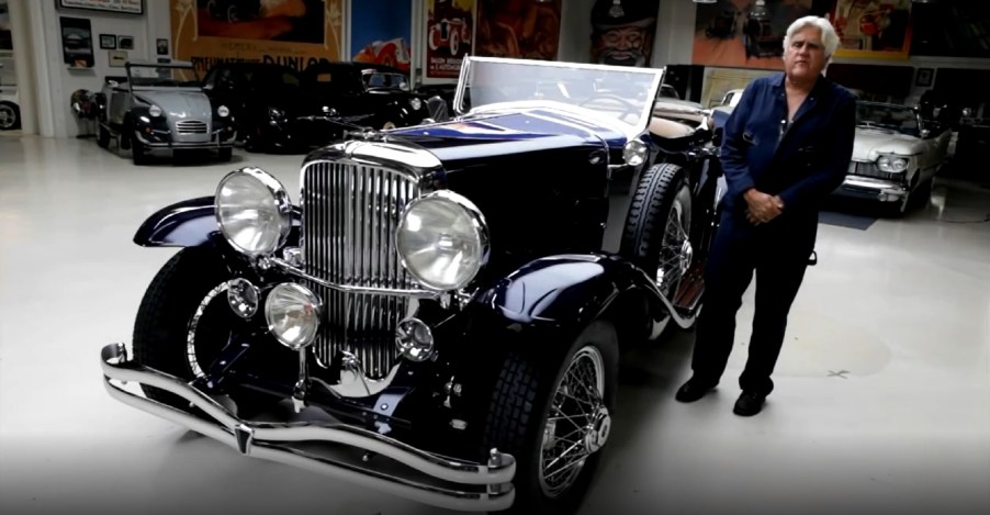 Jay Leno and his dark-blue 1930 Duesenberg LeBaron