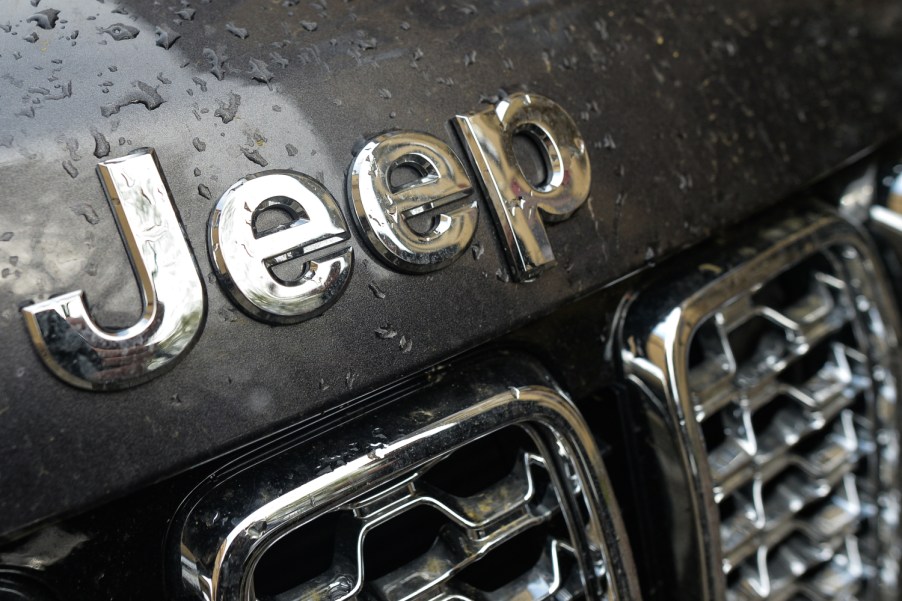 Close-up of the Jeep logo above the iconic seven-slot grille of a Jeep SUV