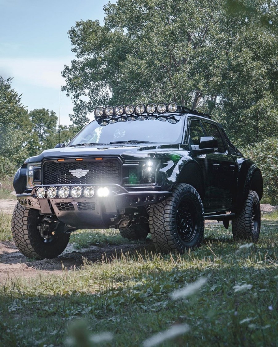 A black Mil-Spec supercharged Intrepid Ford F-150 in a forest