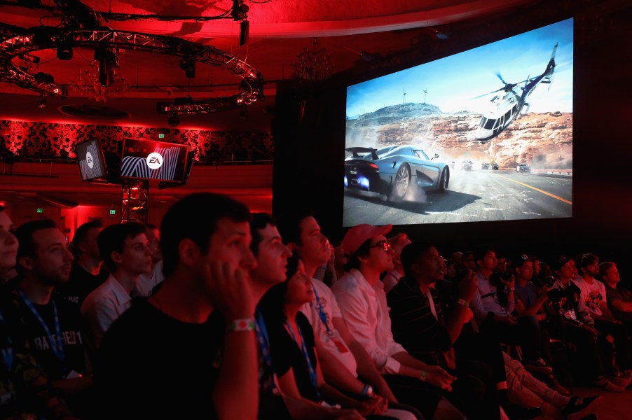 An audience watches debut footage of the PS4 video game Need for Speed Payback at E3.