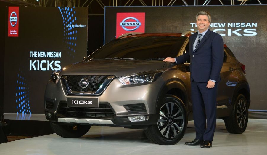 Nissan India's president Thomas Kuehl poses with the new compact SUV 'Kicks' during its launch in Mumbai