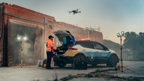 A first responder next to a Nissan Re-Leaf, based on the Nissan Leaf EV, assisting in an emergency response situation.