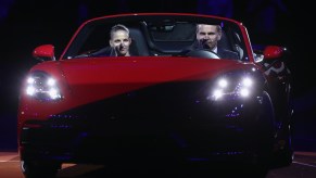 Karolina Pliskova of Czech Republic and Oliver Blume, CEO of Porsche AG, drive on the court with the winner's car Porsche 718 Boxster GTS after Pliskova won the singles final match