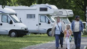 A family walking through an RV park