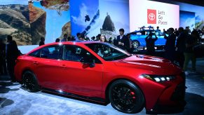 A red Toyota Avalon at an auto show