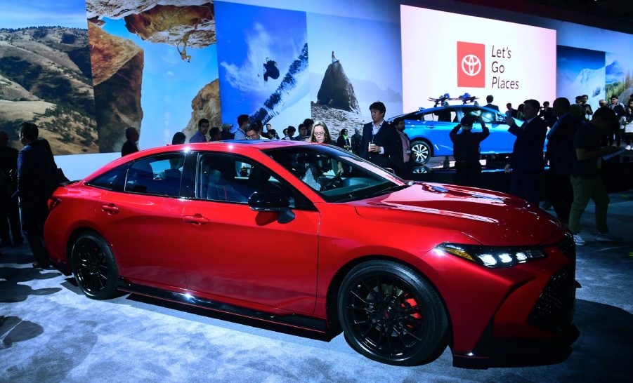 A red Toyota Avalon at an auto show