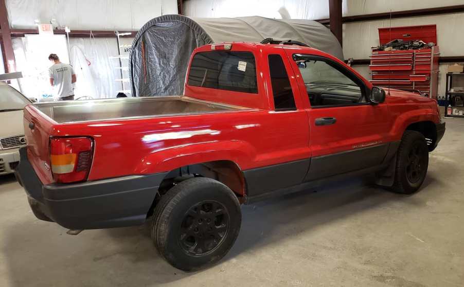 A red Jeep Grand Cherokee has a been cut into a pickup.