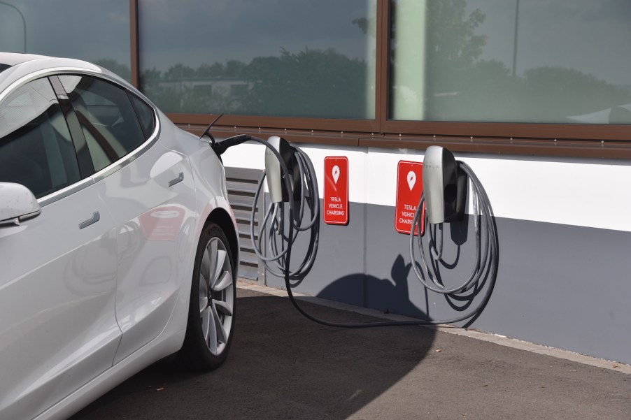 A Tesla Model 3 is charged at the charging station for TESLA electric vehicles, manufacturer of electric vehicles