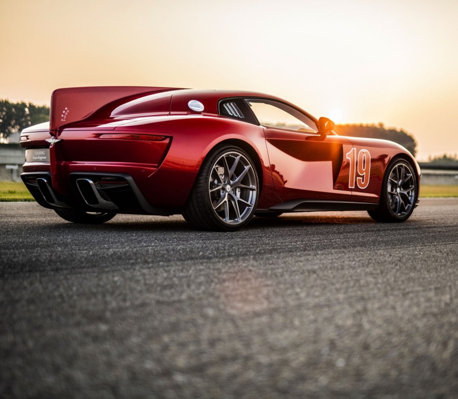 The rear 3/4 of the Touring Superleggera Aero 3 on a racetrack at sunset