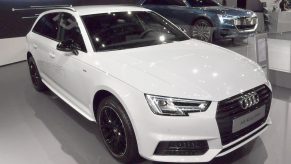 A white Audi A4 on display at an auto show