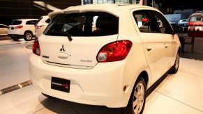 A white Mitsubishi Mirage on display at an auto show