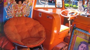 Inside a hippie van with orange decor and a Jimi Hendrix poster