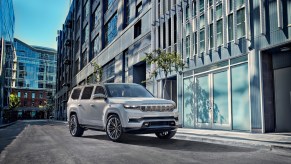 Jeep Grand Wagoneer driving in front of a building