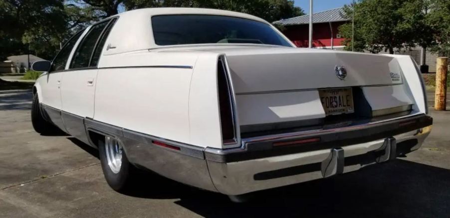 The rear of a white custom 1996 Cadillac Fleetwood Brougham