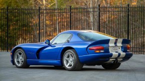 The rear 3/4 view of a blue-and-white 1996 Dodge Viper GTS coupe