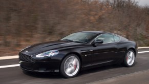 A black 2007 Aston Martin DB9 on a winter road