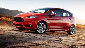 An orange 2014 Ford Fiesta ST parked on desert asphalt