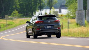 The 2017 Hyundai Tucson driving down a winding road.