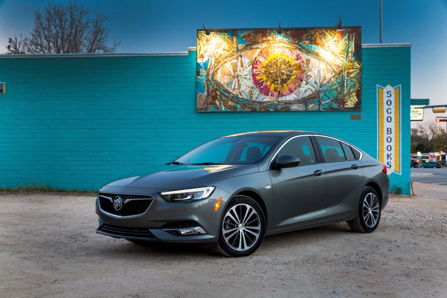 A 2019 Buick Regal Sportback on display in front a blue wall with art hanging above it